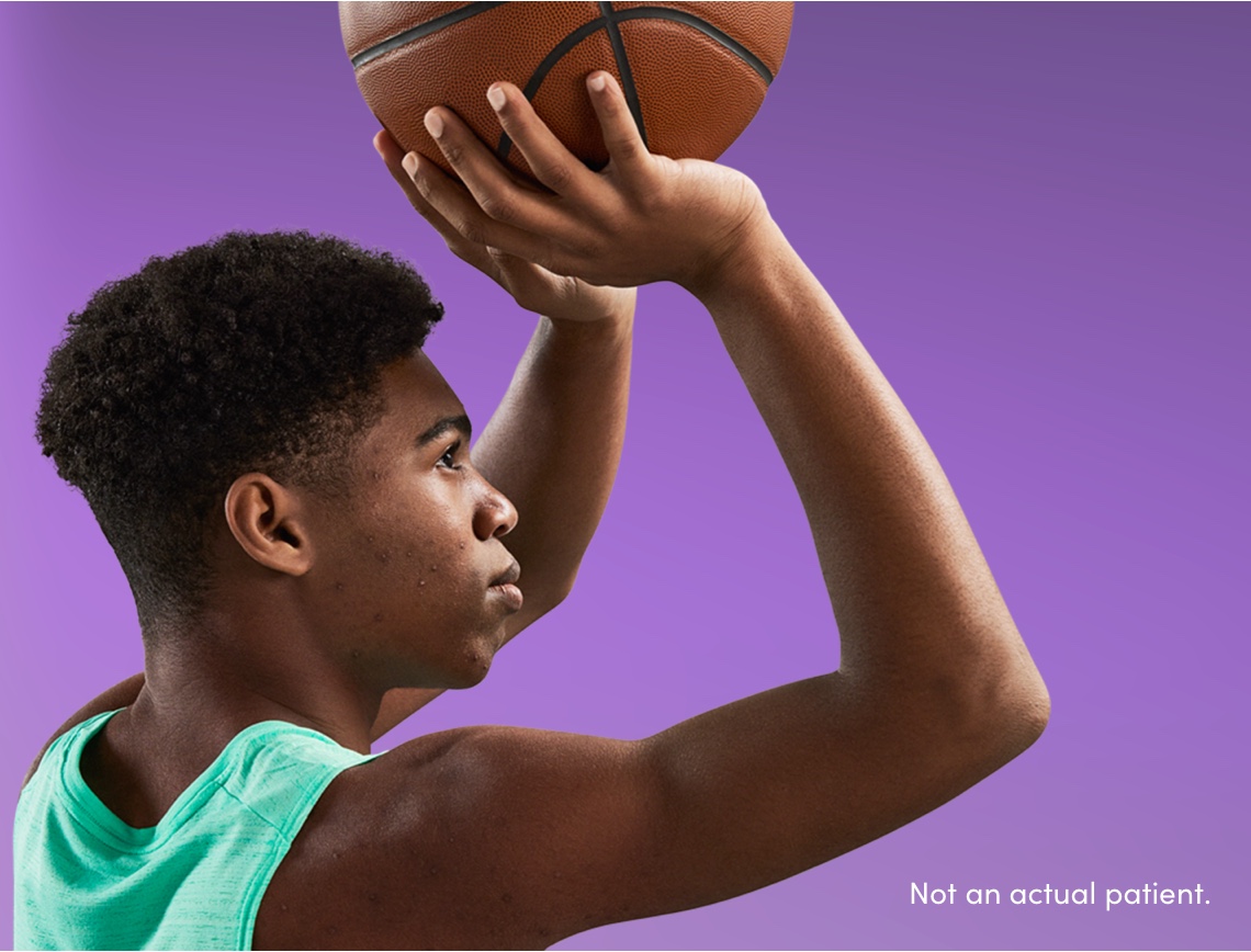 Male teen ready to shoot basketball portrays confident patient saving money on acne treatment with AKLIEF® Cream savings card