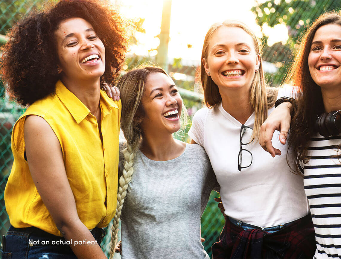 4 teen girls smiling may benefit from AKLIEF® (trifarotene) Cream. In pivotal studies, 300+ were patients with skin of color