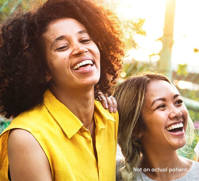 4 teen girls smiling may benefit from AKLIEF® (trifarotene) Cream. In pivotal studies, 300+ were patients with skin of color