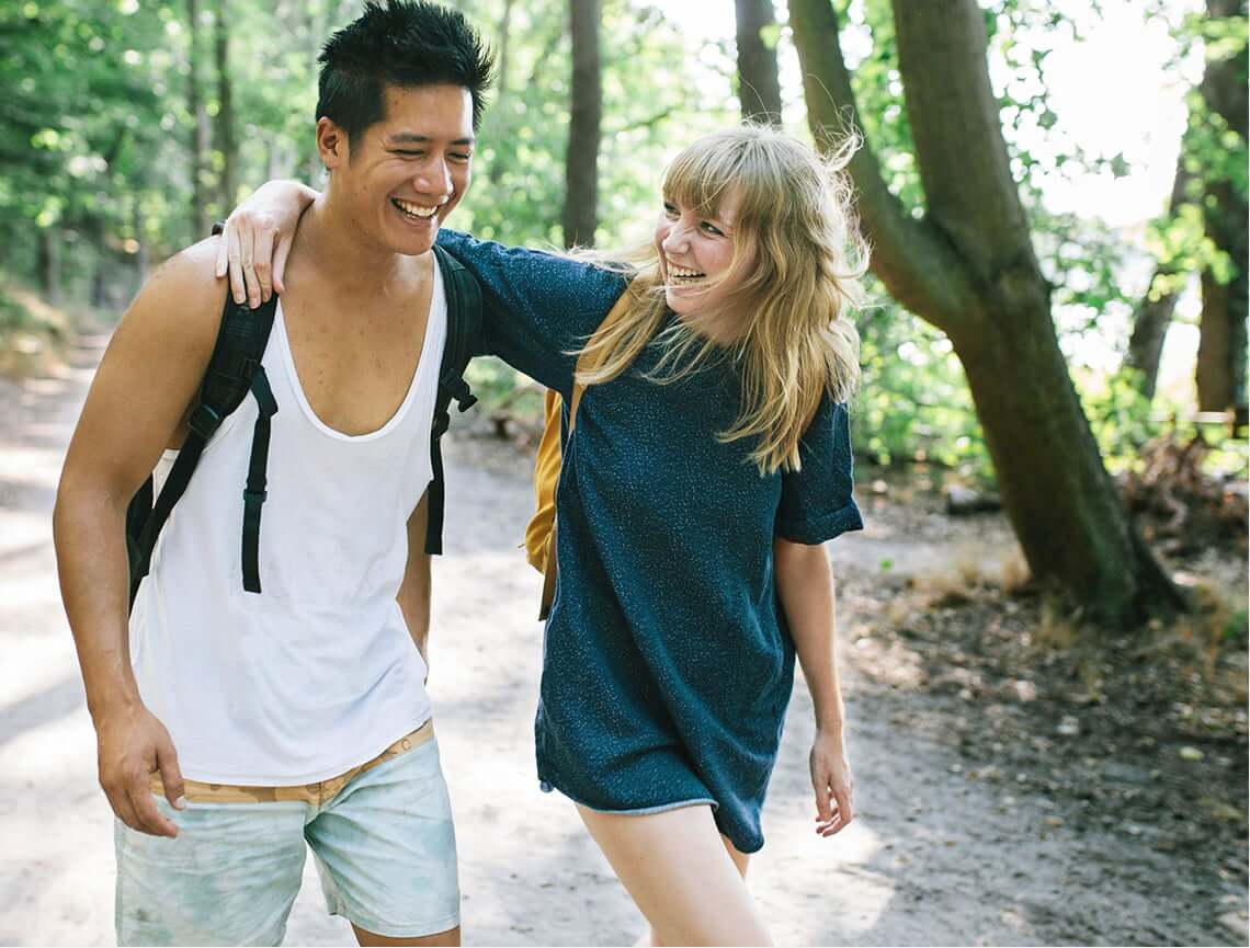 2 smiling teens hiking represent happy patients using patient savings card on AKLIEF® (trifarotene) Cream prescriptions