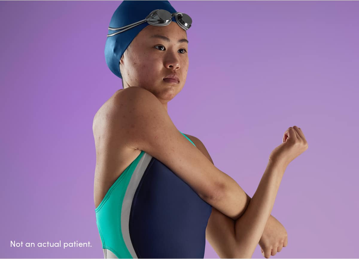 Teen girl swimmer wearing swim cap & goggles has clearer skin, representing how AKLIEF® Cream is effective treating teen acne