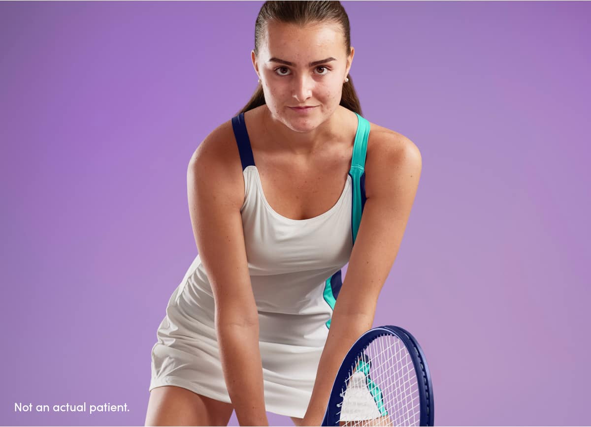 Teen girl with clearer skin ready to return tennis ball reflects AKLIEF® Cream acne treatment that works & builds confidence