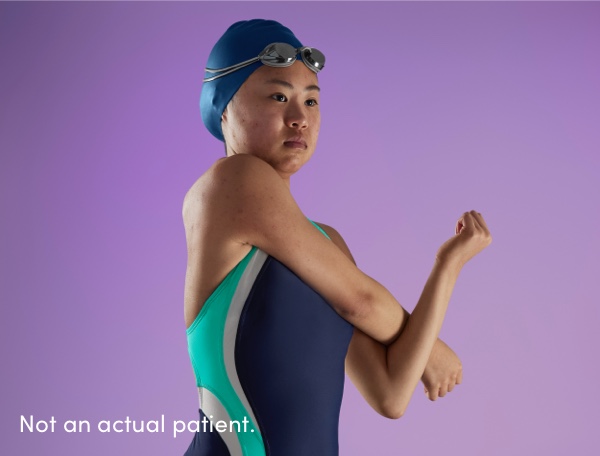 Teen female swimmer stretching arm represents teen acne in skin of color patients benefiting from AKLIEF® (trifarotene) Cream