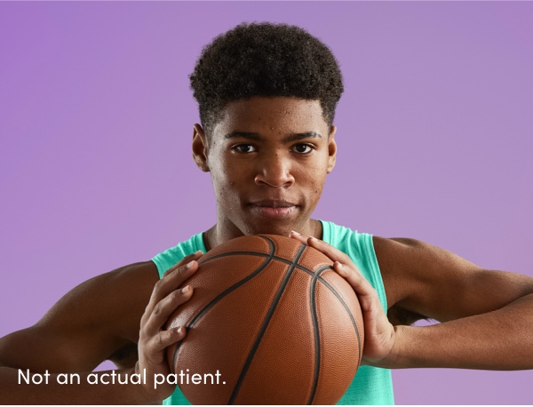 Male grasping basketball reflects teenage acne patients benefited as part of the AKLIEF® (trifarotene) Cream pivotal studies